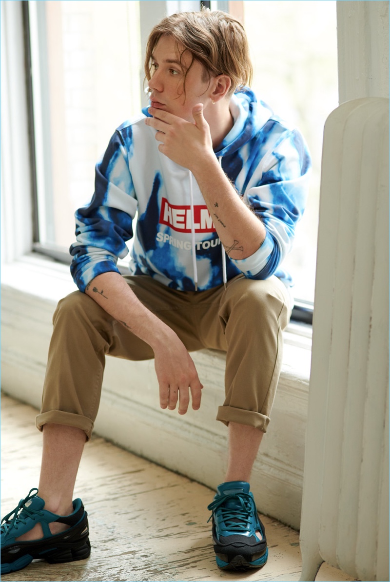 Going casual, Luca Bertea wears Obey pants with a Helmut Lang hoodie and Adidas by Raf Simons sneakers.