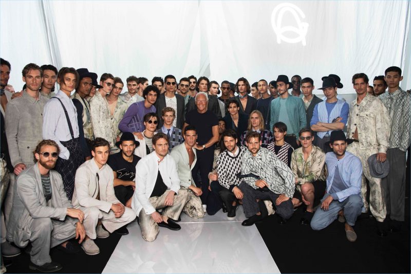 Designer Giorgio Armani poses with the models who walked in his label's spring-summer 2019 show.