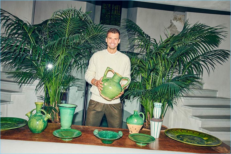 All smiles, Grigor Dimitrov wears a Brunello Cucinelli sweater, Dunhill t-shirt, and Rubinacci trousers.