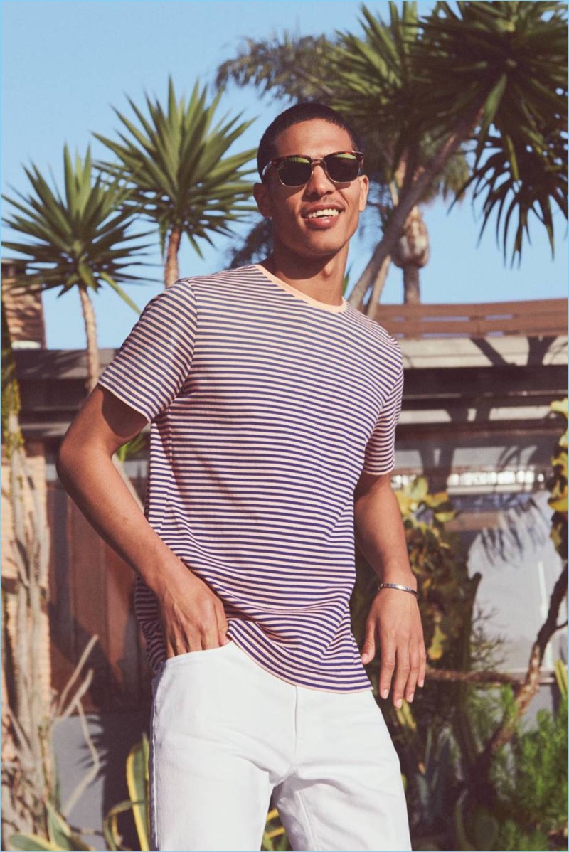 All smiles, Geron McKinley rocks a striped t-shirt and white skinny-fit pants from H&M.