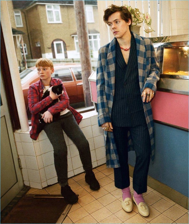 Donning a check coat and sharp suit, Harry Styles stars in Gucci's Tailoring campaign.