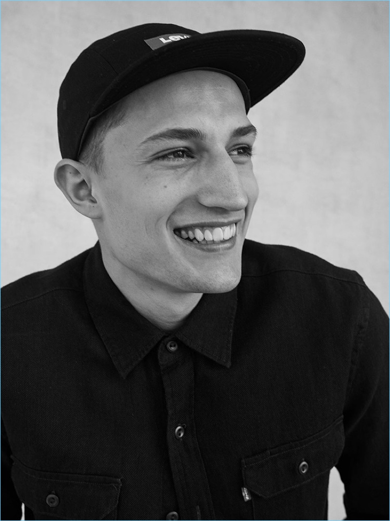 All smiles, Frederik Woloszynski wears a Levi's cap and shirt jacket from the brand's fall 2018 collection.