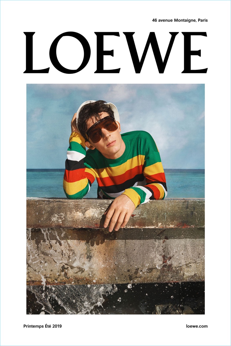 Actor Josh O’Connor wears a colorful striped sweater for Loewe's spring-summer 2019 campaign.