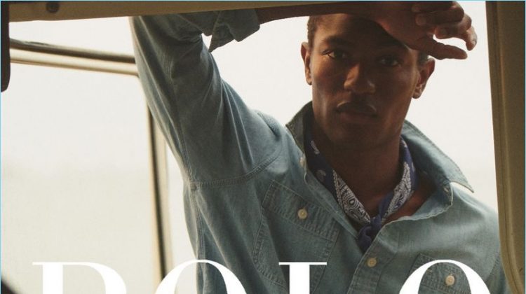 Hamid Onifade wears a denim shirt and khaki shorts fro POLO Ralph Lauren's summer 2018 campaign.