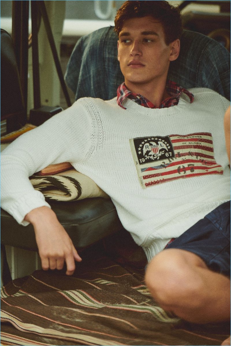 Jegor Venned sports a flag sweater and plaid shirt for POLO Ralph Lauren's summer 2018 campaign.