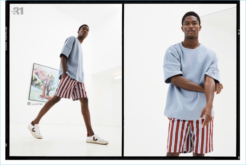 Front and center, Hamid Onifade wears a LE 31 boxy sweatshirt and retro-stripe Bermuda shorts with Veja sneakers.