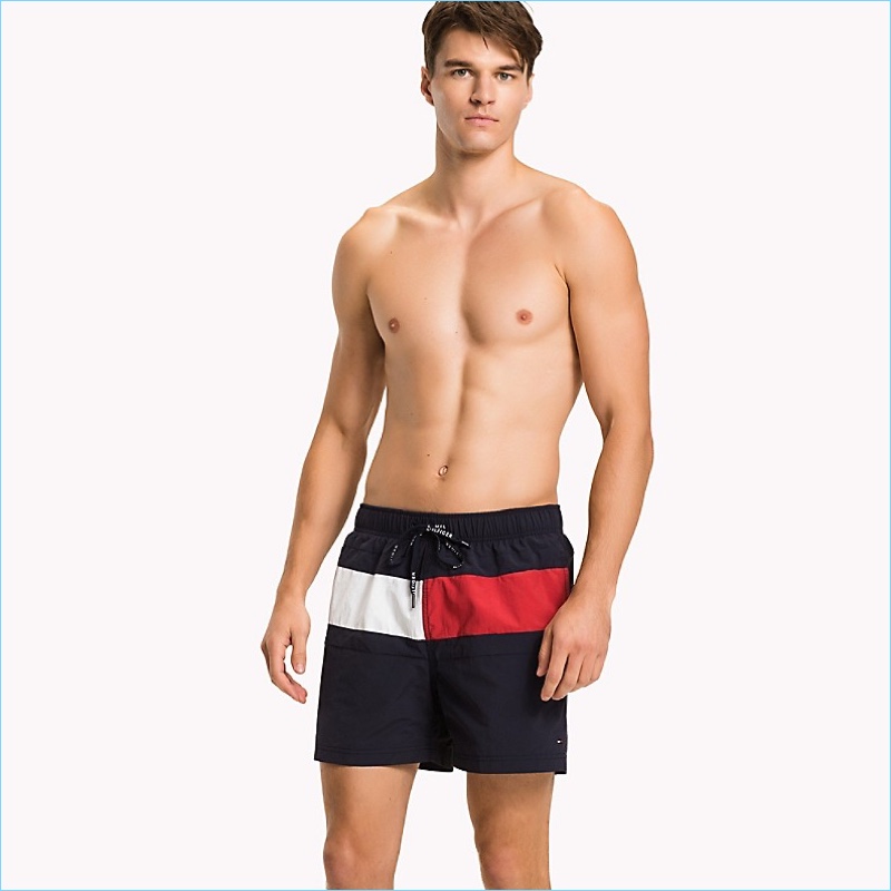 Arran Sly wears Tommy Hilfiger's Flag mid-length swim trunks.