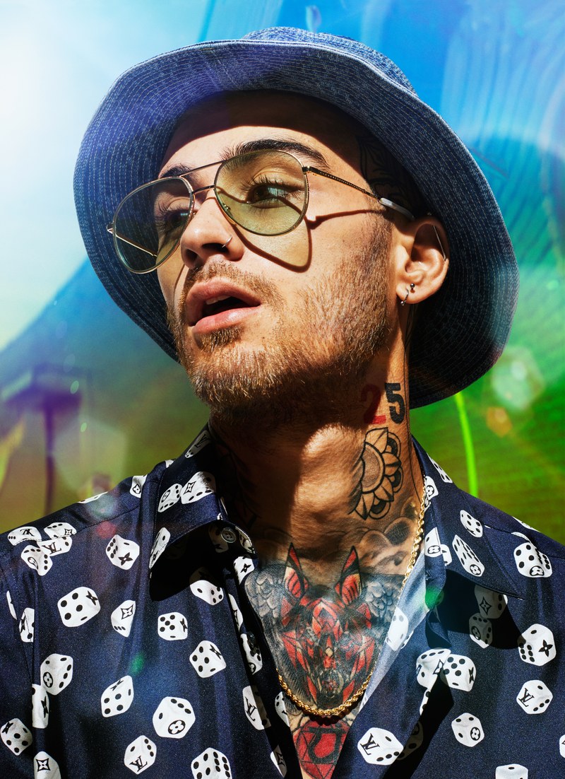 Singer Zayn Malik wears a shirt and hat by Louis Vuitton with Gucci sunglasses.