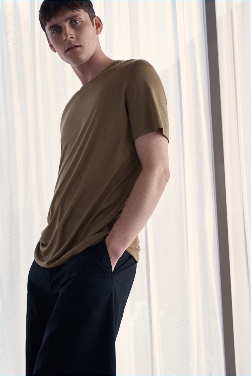Connecting with COS, Anders Hayward wears a relaxed tee in brown.