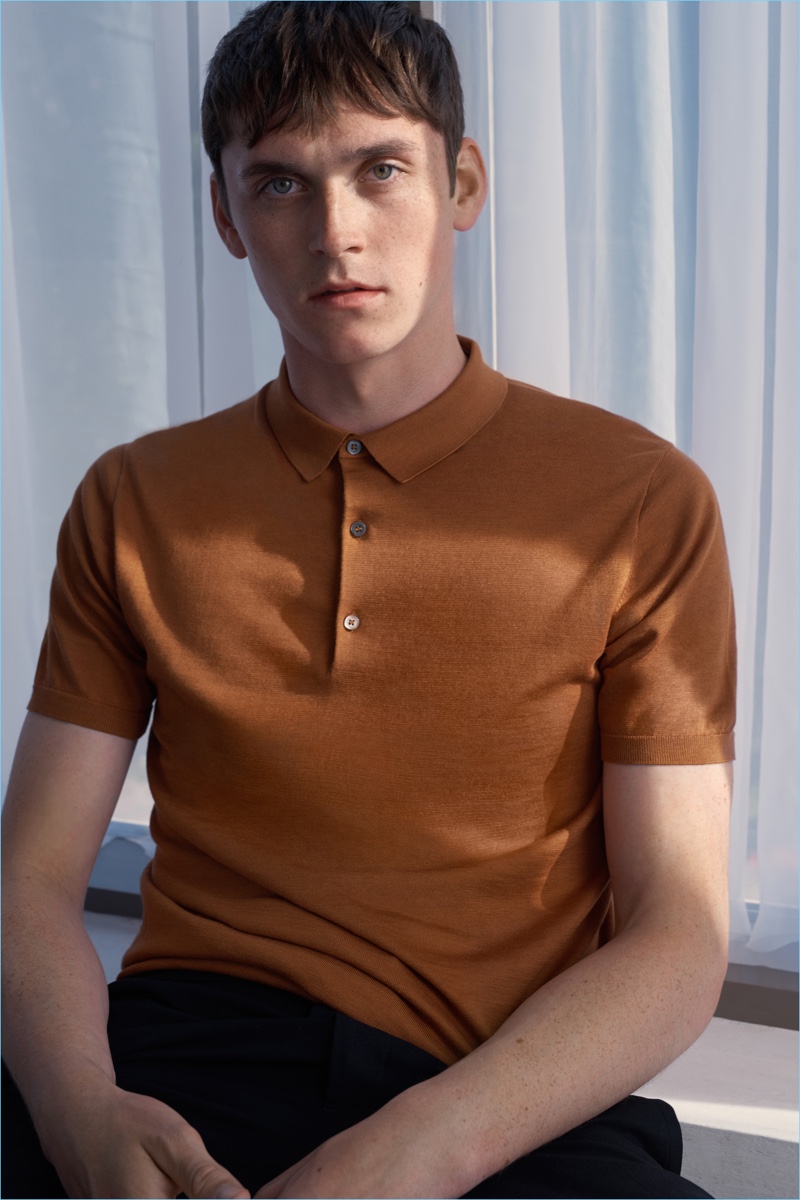 Anders Hayward wears a COS silk-cotton polo shirt in golden yellow.