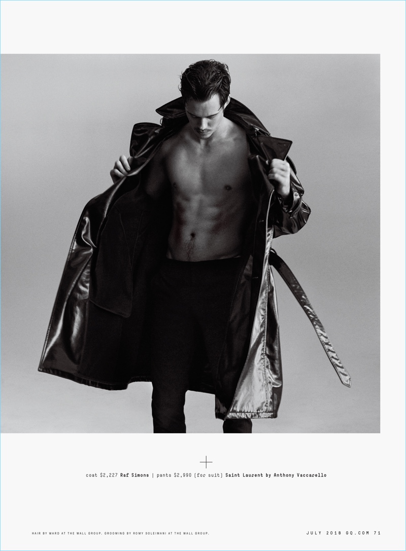 Actor Bill Skarsgård dons a Raf Simons coat and Saint Laurent trousers.