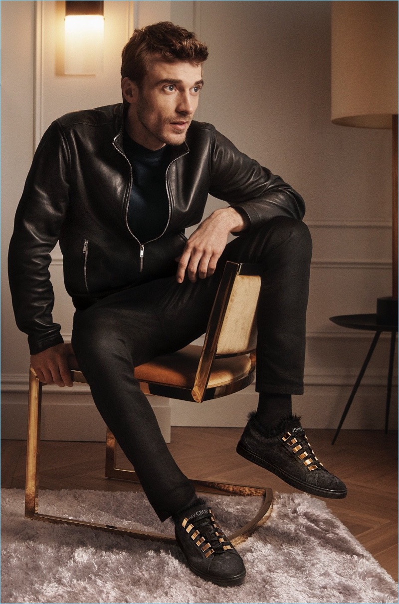 Going casual, Clément Chabernaud dons Jimmy Choo's velvet Cash sneakers for the label's fall-winter 2018 campaign. The luxurious sneakers feature a fur lining.