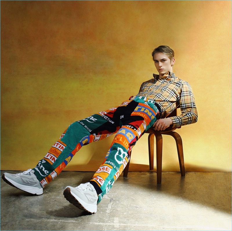 Mixing prints, Dominik Sadoch sports a check Burberry shirt with patchwork trousers by Martine Rose and Hi-Tec HTS4 sneakers.