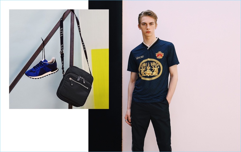 Embracing simple style, Dominik Sadoch wears a football t-shirt and track pants by Versace. Pictured left: Maison Margiela sneakers and a Valentino cross-body bag.