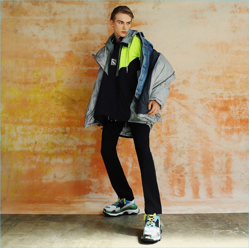 Tapping into the oversized trend, Dominik Sadoch wears a denim jacket, windbreaker, and more from Balenciaga.