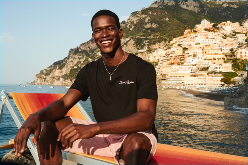 All smiles, Salomon Diaz wears a H&M t-shirt and pink corduroy shorts.