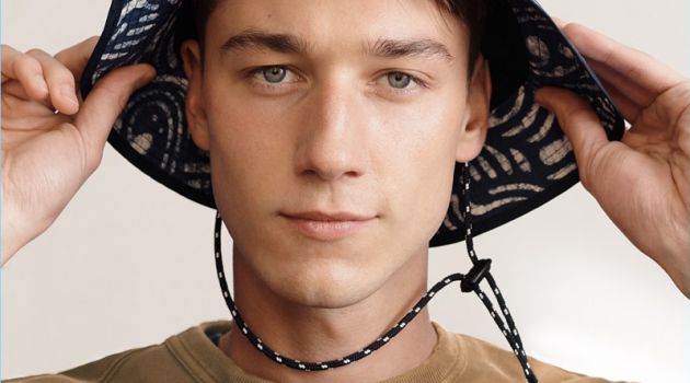 J.Crew Shares Its Summer Cheatsheet with Timely Essentials Harvey James sports a Wallace & Barnes garment-dyed sweatshirt with a J.Crew bucket hat.
