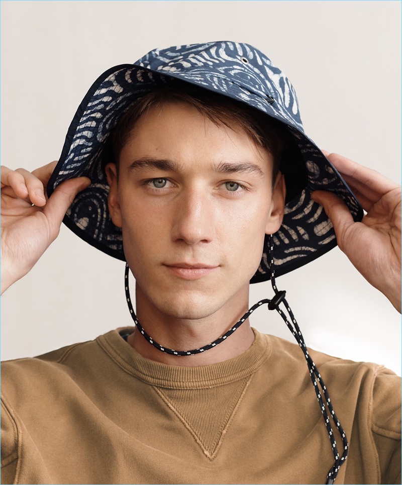 Harvey James sports a Wallace & Barnes garment-dyed sweatshirt with a J.Crew bucket hat.