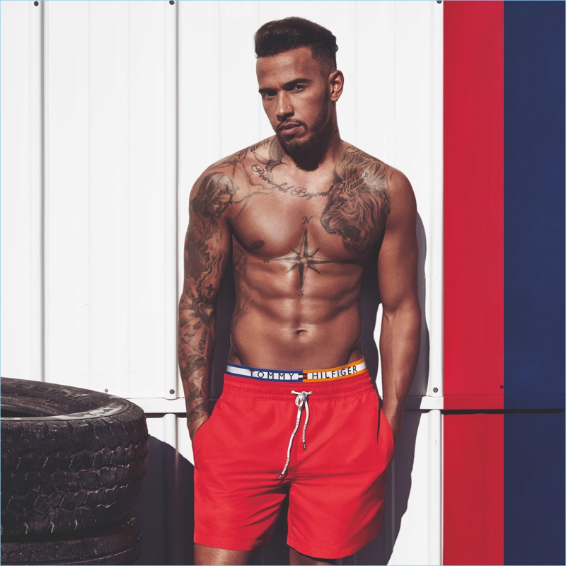 Lewis Hamilton goes shirtless showing off his tattoos in a Tommy Hilfiger image.