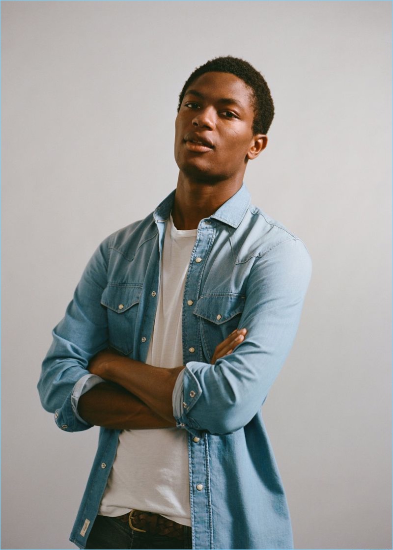 Model Hamid Onifade dons a light wash denim shirt from Mango Man.