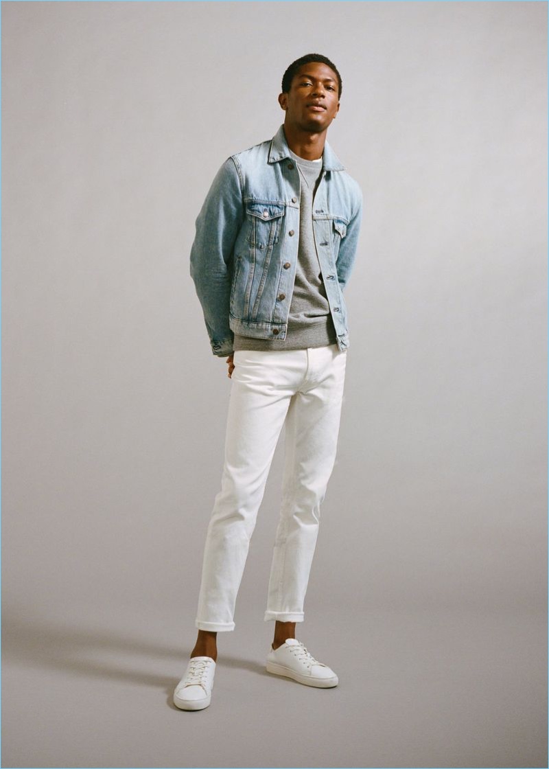 Standing tall, Hamid Onifade wears white jeans and a denim jacket by Mango Man.