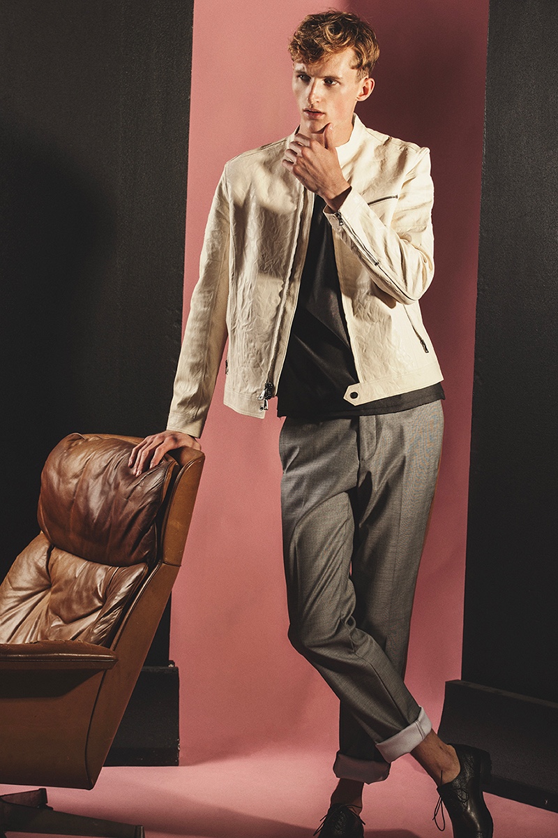 Mark wears t-shirt Messagerie, leather jacket John Varvatos, trousers N°21, and shoes Coach.