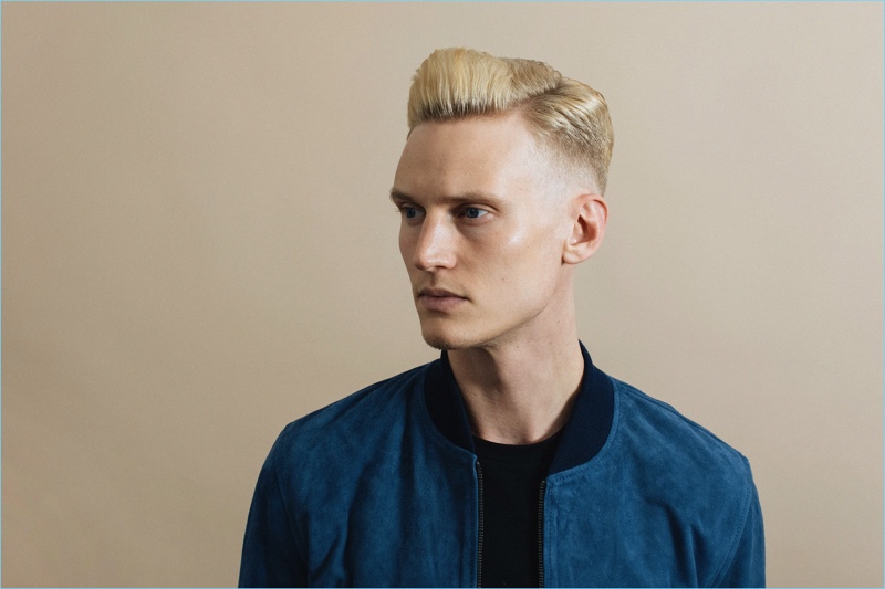 Alexander Johansson sports a side part faded to skin hairstyle.