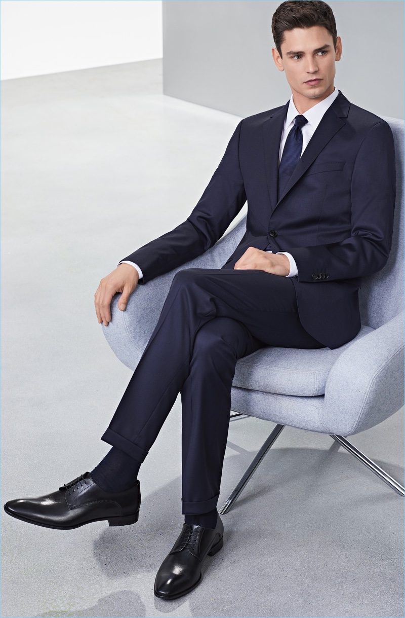 Arthur Gosse dons a sharp suit and dress shoes from BOSS.