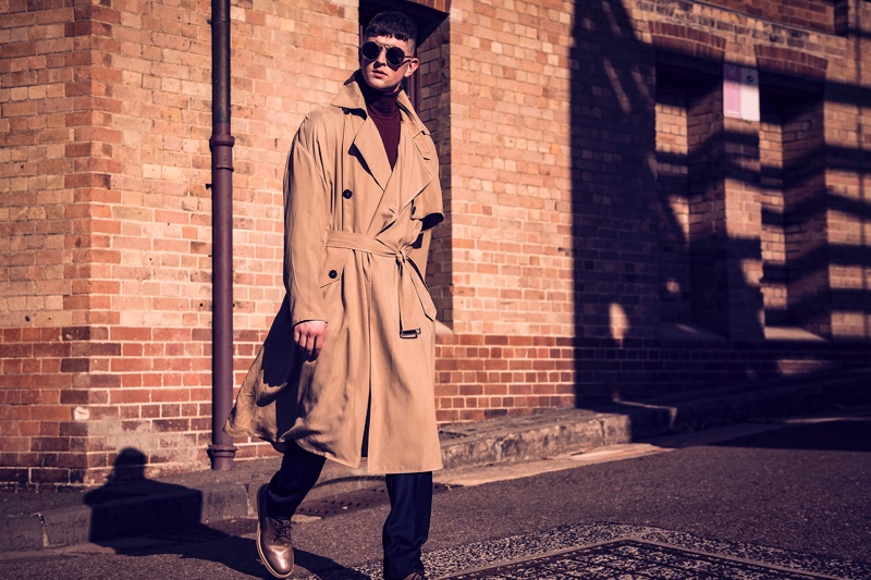 Michael wears trench coat and sunglasses Giorgio Armani,  knitwear and pants P Johnson Tailors, and shoes Salvatore Ferragamo.