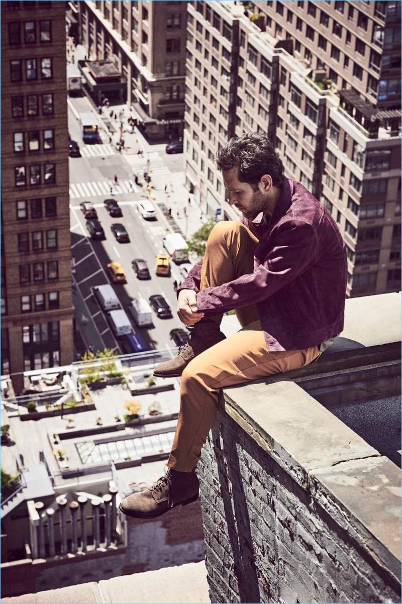 Overlooking New York, Paul Rudd wears a Berluti suede blouson jacket, Massimo Alba t-shirt, and Sandro cropped trousers. Officine Creative suede boots complete his look.