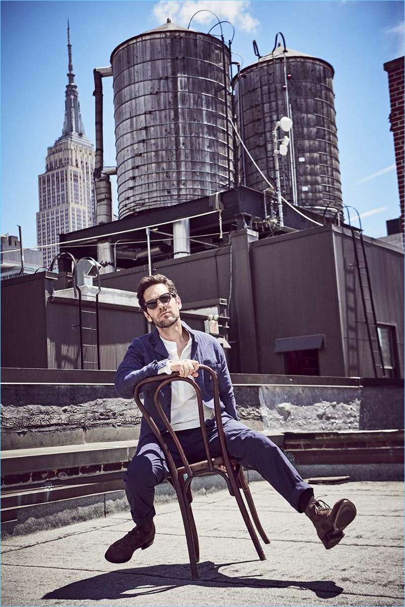 Connecting with Mr Porter, Paul Rudd wears a Folk camp-collared shirt and Officine Generale grandad-collared shirt. Mr P. chinos, Officine Creative suede boots, and Jacques Marie Mage sunglasses complete Rudd's look.