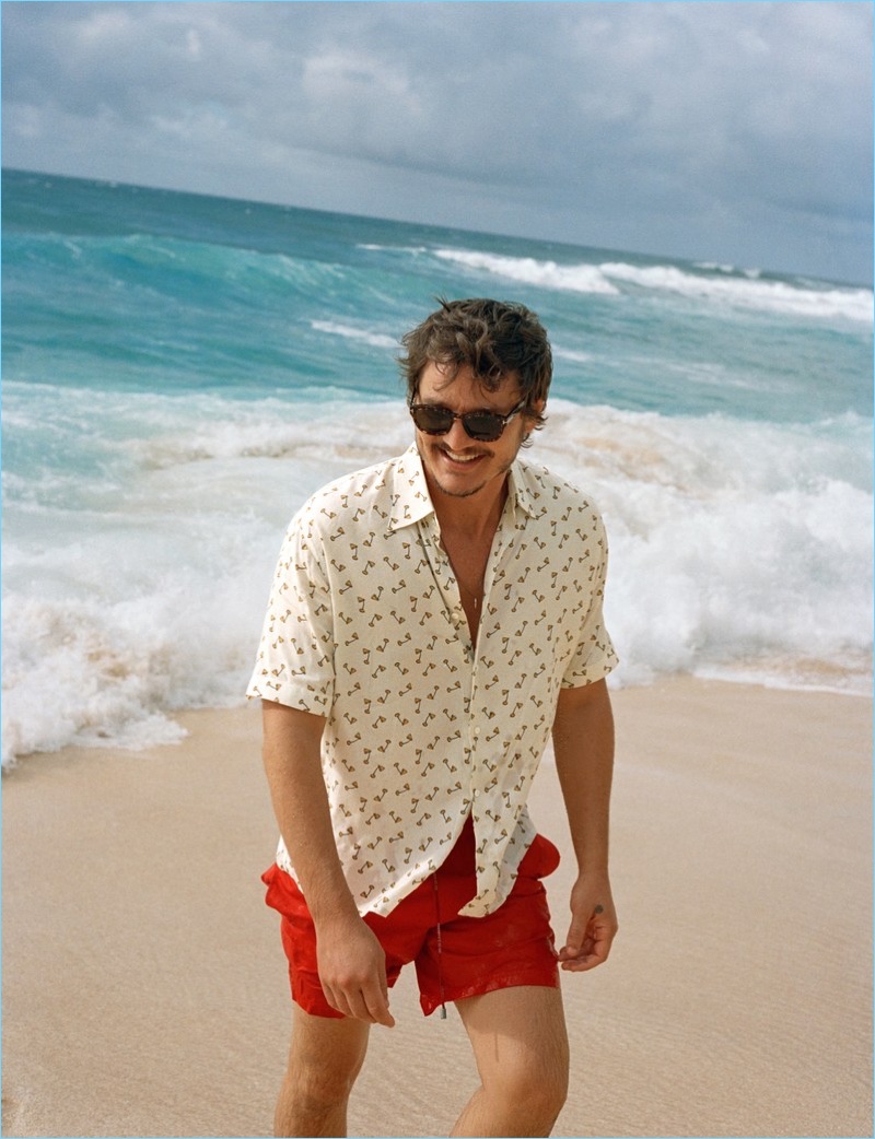 Pedro Pascal wears Dolce & Gabbana swim shorts with a Fendi shirt and Tom Ford sunglasses.