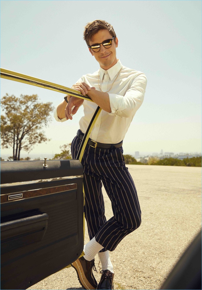 All smiles, Antoni Porowski wears a Stella McCartney shirt, Goodfight trousers, and Louis Vuitton shoes. He also dons a Topman belt and Illesteva sunglasses.