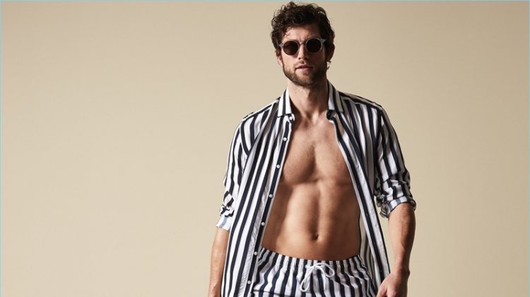 Making a striped statement, Jan Trojan wears Reiss' Flint stripe swim shorts in navy.