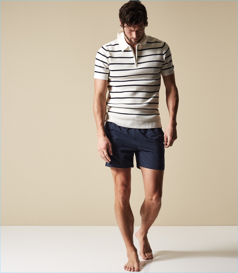 Ready for the beach, Jan Trojan models Reiss' navy Sonar drawstring swim shorts with a half-zip polo.