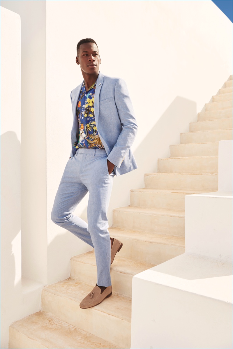 David Agbodji dons a light blue suit with a Hawaiian shirt by River Island.