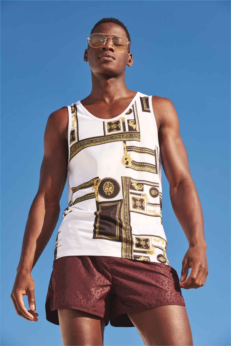 Model David Agbodji is a summertime vision in a tank and swim shorts from River Island.