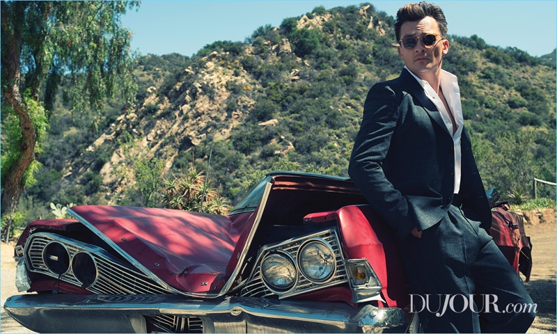 A sleek vision, Rupert Friend dons a Stella McCartney shirt and suit. He also wears Oliver Peoples sunglasses.