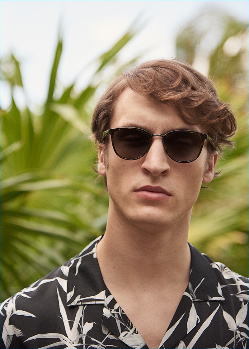 Connecting with Matches Fashion, Tim Dibble rocks Prada sunglasses with a Commas shirt.