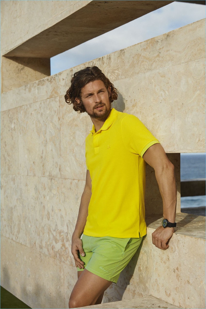 Dutch model Wouter Peelen sports a yellow polo with green swim shorts from Vilebrequin.