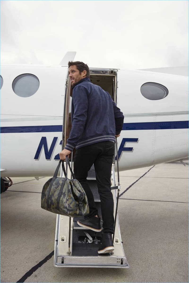 Boarding a plane, Albert Reed dons Banana Republic's 5-Pocket Traveler Pant.