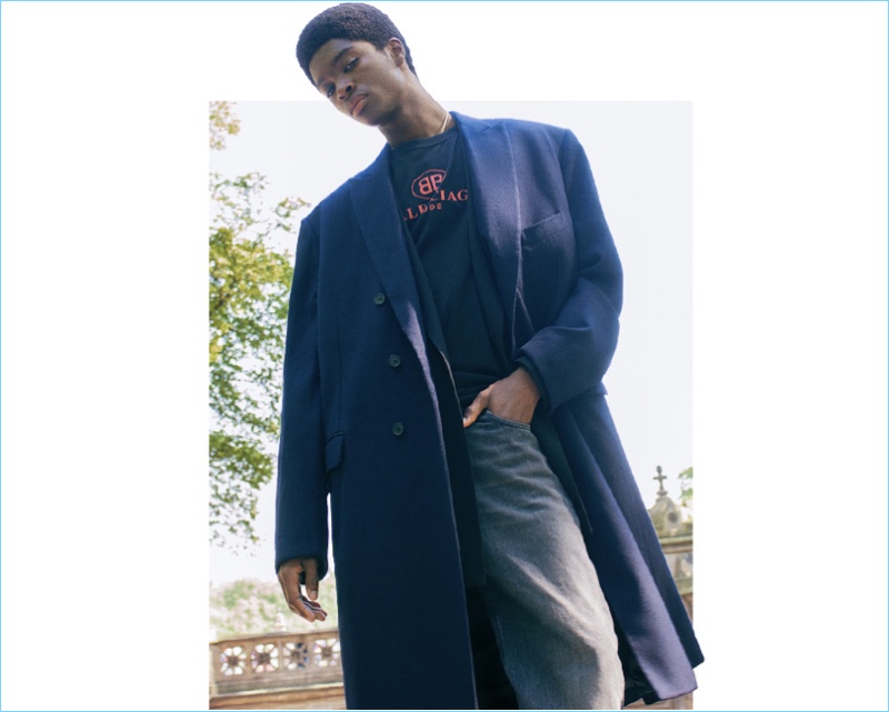 Making an oversized statement, Alton Mason sports a coat, jacket, t-shirt, and jeans, all by Balenciaga.