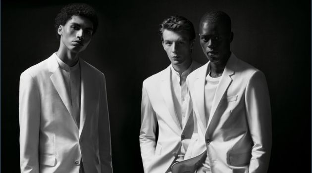 Models Sol Goss, Finnlay Davis, and Alpha Dia don white suits from the BOSS x Michael Jackson capsule collection.