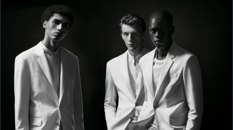 Models Sol Goss, Finnlay Davis, and Alpha Dia don white suits from the BOSS x Michael Jackson capsule collection.