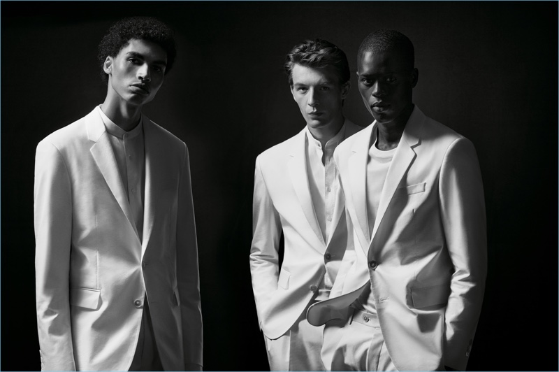 Models Sol Goss, Finnlay Davis, and Alpha Dia don white suits from the BOSS x Michael Jackson capsule collection.