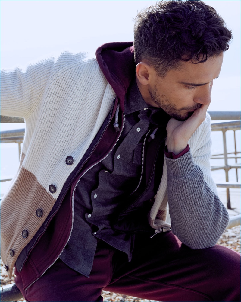 Connecting with Neiman Marcus, Arthur Kulkov wears a Brunello Cucinelli quilted vest, hoodie, shawl cardigan, pants, and shirt.