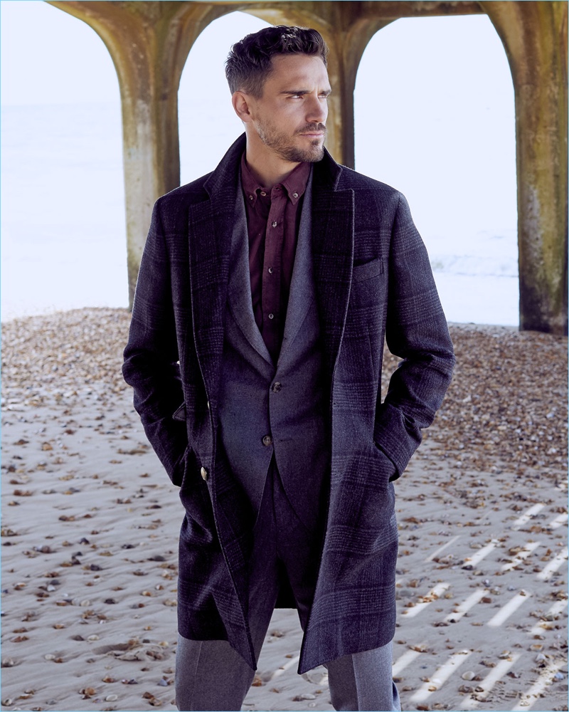 A sleek vision, Arthur Kulkov dons a Brunello Cucinelli suit, overcoat, and shirt.