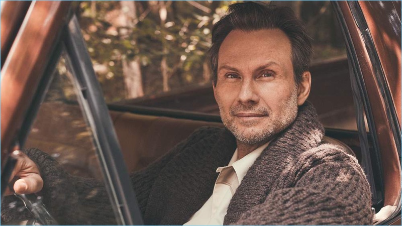 Sporting a Brioni shawl-collar cardigan, Christian Slater also wears a Maison Margiela shirt.