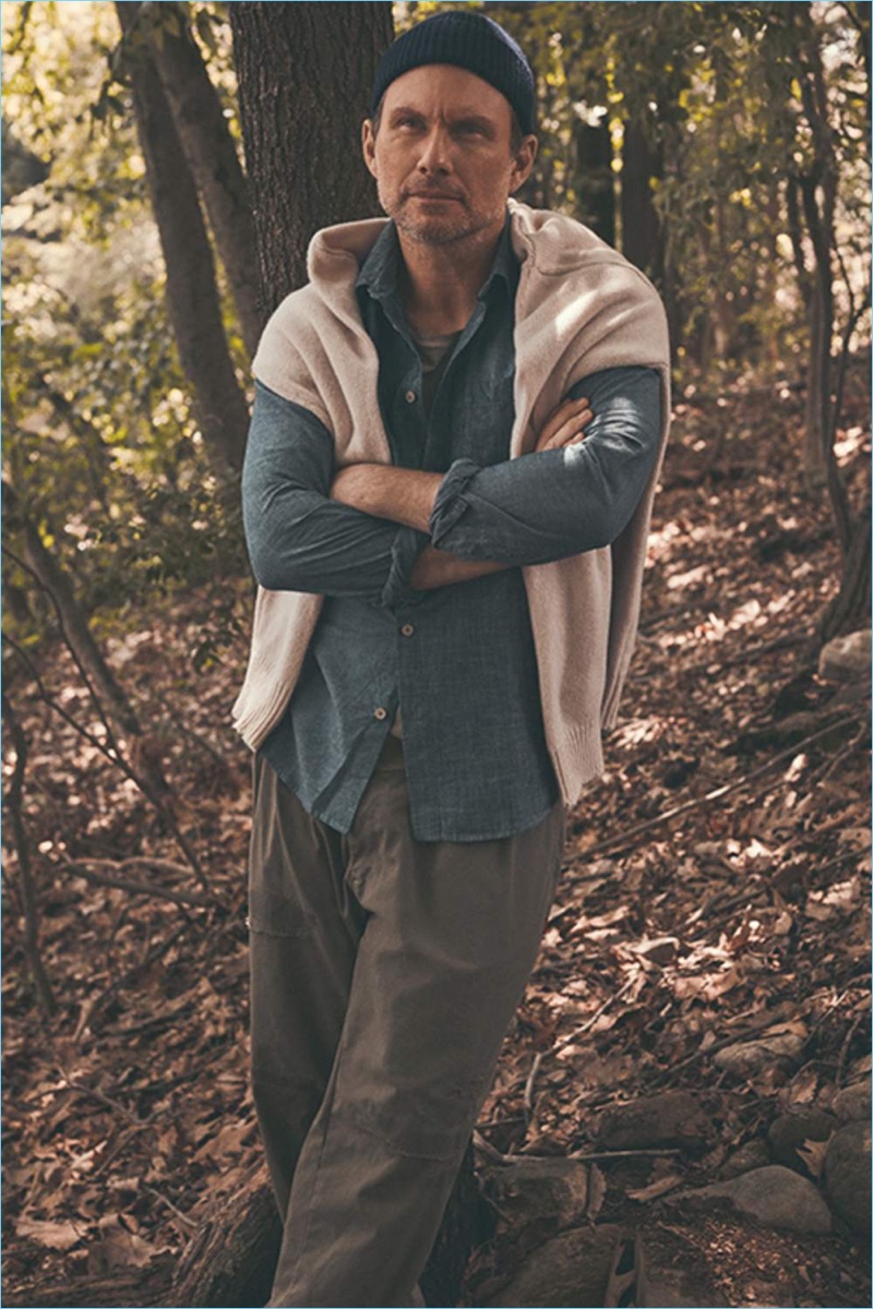 Venturing outdoors, Christian Slater wears a Maison Margiela sweater, Folk chambray shirt, Enlist t-shirt, Beams trousers, and a beanie by Anderson & Sheppard.