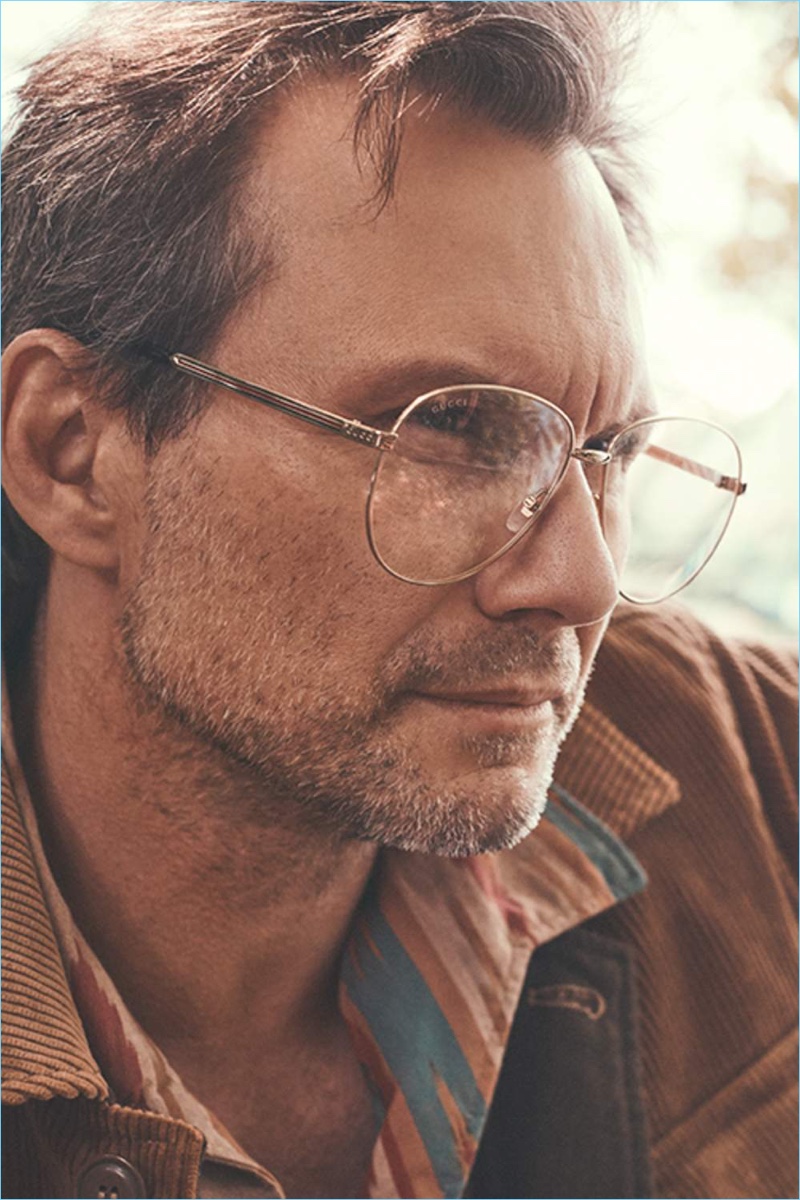 Actor Christian Slater sports an Aspesi corduroy jacket, Battenwear shirt, and Gucci glasses. 